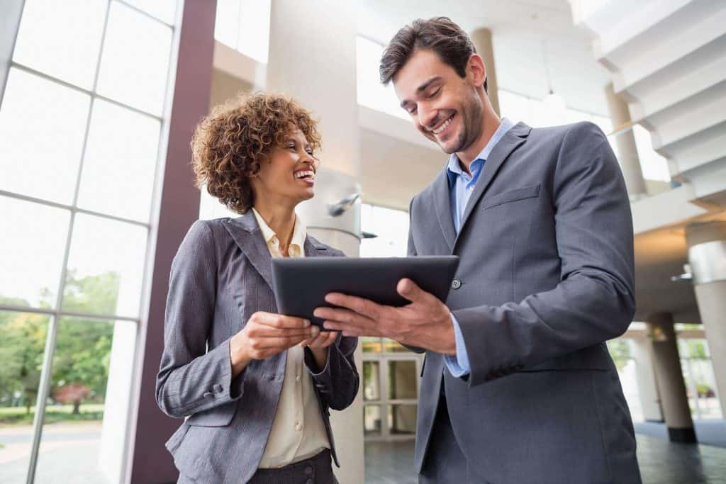 Employees using a tablet - technology in business - business growth