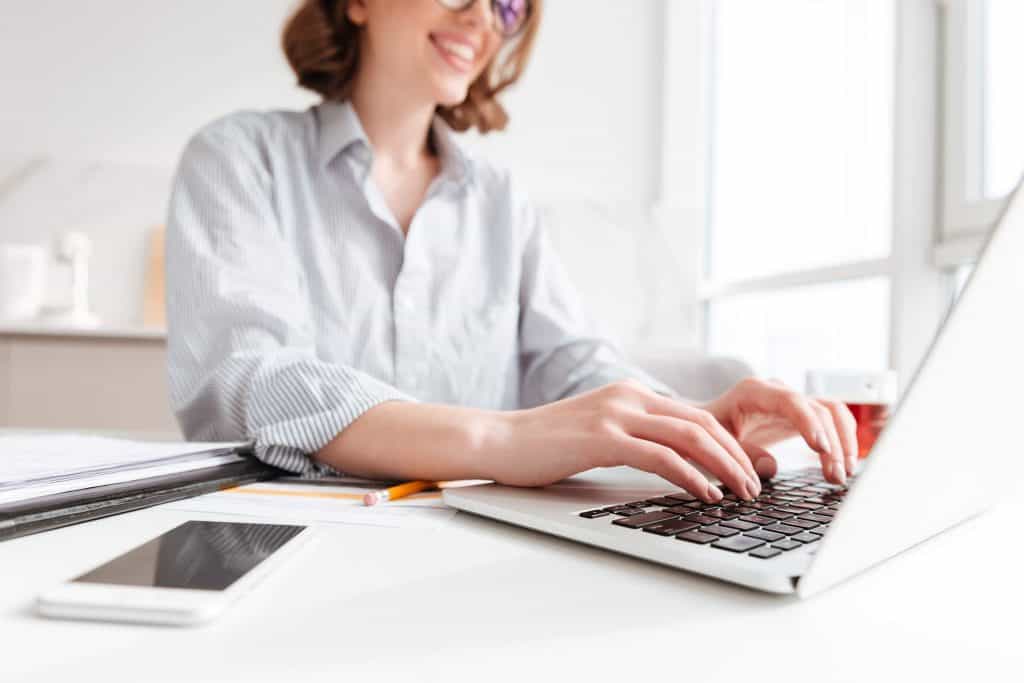woman-typing-email-laptop-computer-while-working- from- home - business - security